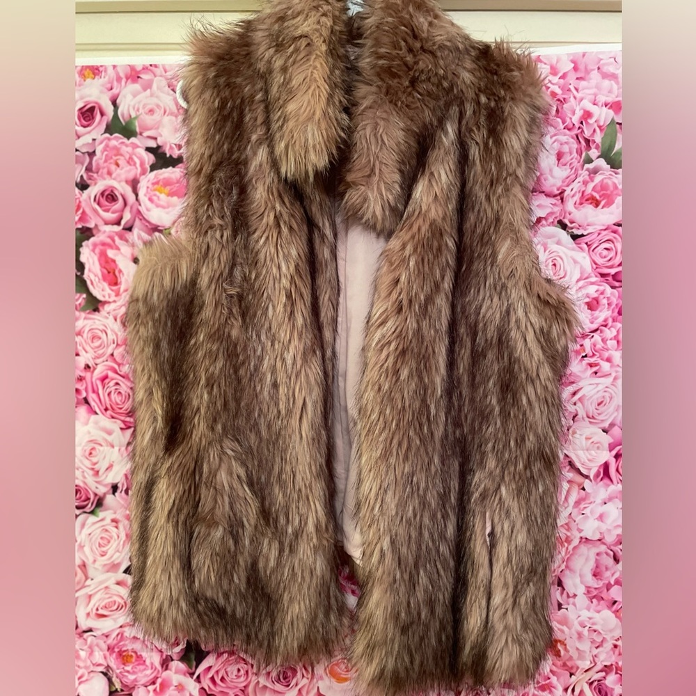 Rose colored fur vest mixed with black fully lined with side pockets